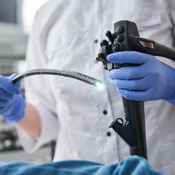 Doctor holding endoscope during gastroscopy in hand