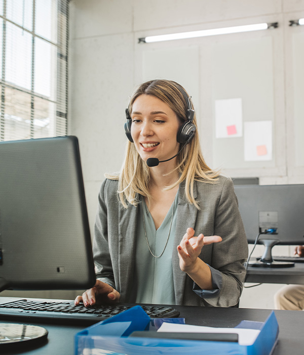 Friendly colleagues in call center service talking with costumers by headset